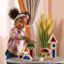 Girl playing with large acrylic coloured see through sensory blocks