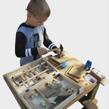 Child playing with real wood tools workshop on a white background