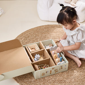 Child playing with wooden toys in a box on a carpeted floor