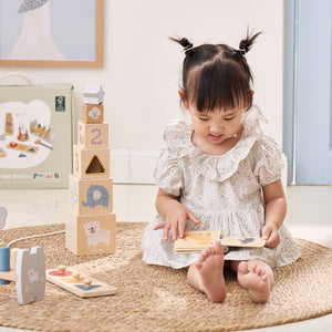 Child playing with wooden toys on a carpeted floor