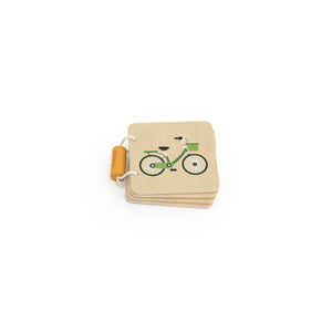 Small wooden book with a bicycle illustration on a white background