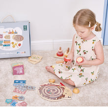 Young girl playing with wooden toys on a carpeted floor wooden toys toddler learning toys