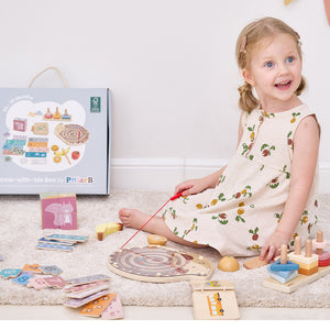Child playing with wooden toys on a carpeted floor, with a toy box in the background. learning toys