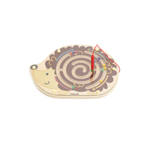 Wooden snail maze toy with a red string on a white background tracing toy