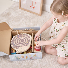 Child playing with wooden toys in a box on the floor wooden toys educational toys