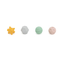 Set of five colorful baby teething rings on a white background