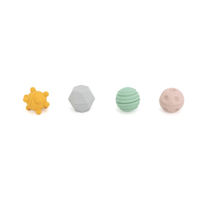 Set of five colorful baby teething rings on a white background