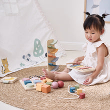 Child playing with wooden toys on a carpeted floor toddler montessori