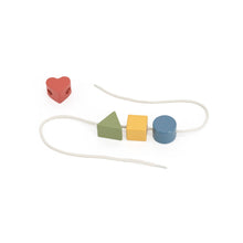 Colorful wooden beads on a string with a heart-shaped bead on a white background