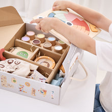 Child unpacking wooden toys educational learning toy box