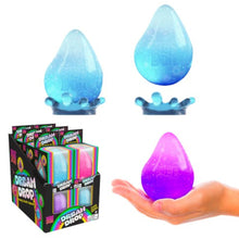 Colorful 'Dream Drop' toys with packaging and a hand holding one.