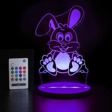 Colorful rabbit-shaped night light with remote control on a dark background