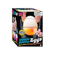 Box of Dippin' Dazzler Eggs with a color-changing egg and water cup on a white background