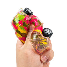 Colorful object held in a hand against a white background