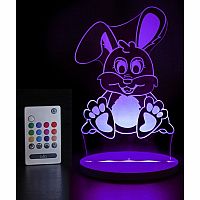 Colorful rabbit-shaped night light with remote control on a dark background