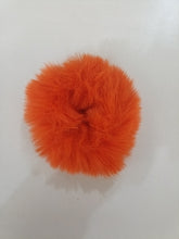 Orange fluffy ball on a white background