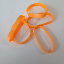 Orange rubber bands on a white background