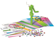 Children's jewelry-making kit with beads, tool, and colorful mat on a white background