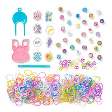 Assorted rubber band charms and tools on a white background