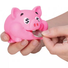 Pink piggy bank with a coin being inserted into it, held by a hand on a white background