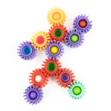 Colorful gear toys arranged in a pattern on a white background