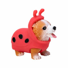 Dog figurine wearing a red ladybug costume on a white background