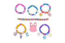 Set of colorful bracelets with charms on a white background