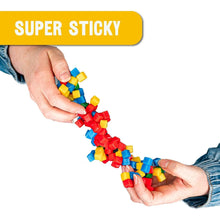 Colorful magnetic building blocks being held by hands with a 'Super Sticky' label above.