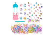 Assorted colorful rubber band charms and tools on a white background