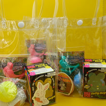 Collection of pet toys in clear bags on a yellow background
