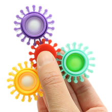 Colorful fidget spinner toys held by a hand on a white background
