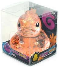 Glowing orange duck toy in packaging with brand logo