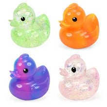 Four colorful rubber ducks with glittery finish on a white background