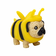 Toy figure of a dog in a bee costume on a white background