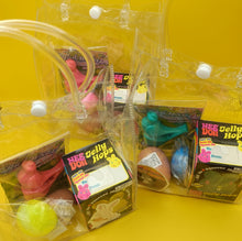 Assorted pet toys in clear packaging on a yellow background