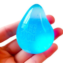 Blue teardrop-shaped object held in a hand with a white background