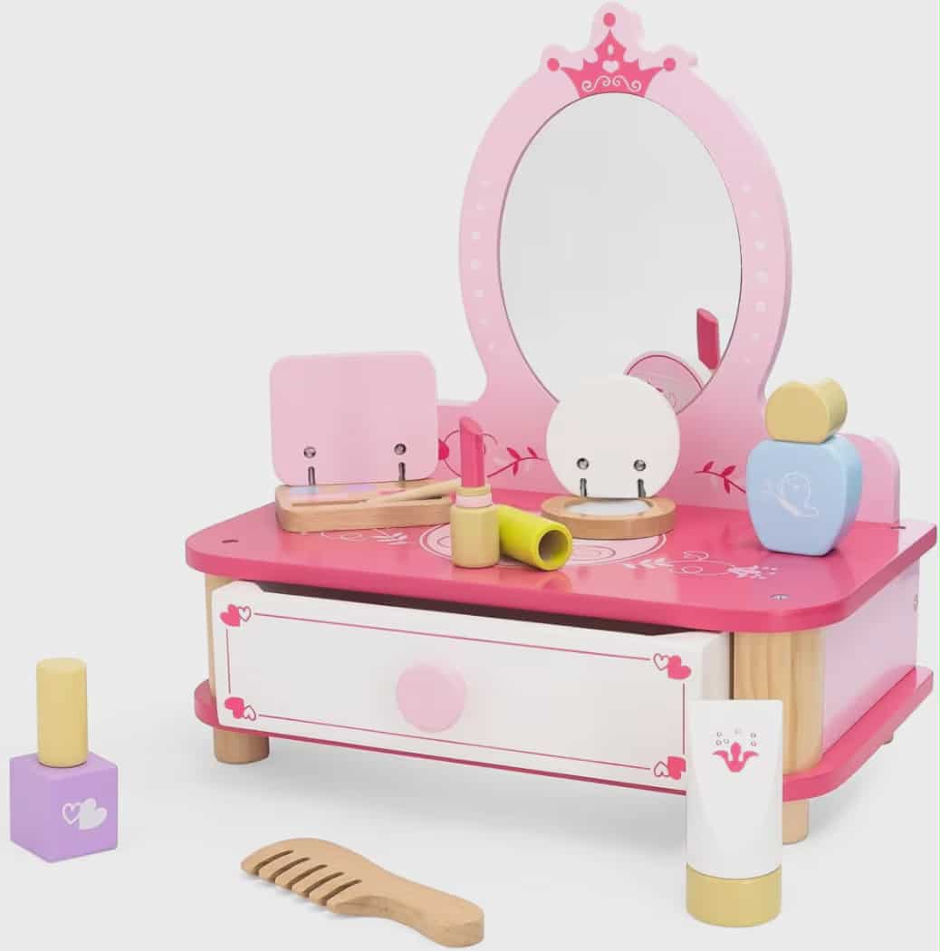 Pink toy vanity set with mirror, drawers, and various accessories on a white background