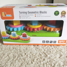 Stacking  gears puzzle - Stack the correct gear with the correct shape and turn to make all the wooden pieces spin